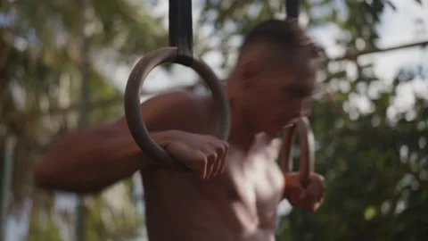 Muscular athletic young man exercising on gymnastic rings. Sport and health care Vídeos de archivo 206159103