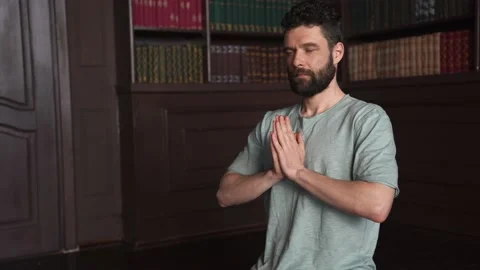 Muscular Attractive Man Sitting Basic Yoga Pose, Deep Breathing and Meditating Stock Footage 152568378