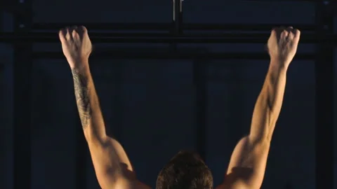 Muscular back of young bodybuilder training in dark background Stock Footage 91135556