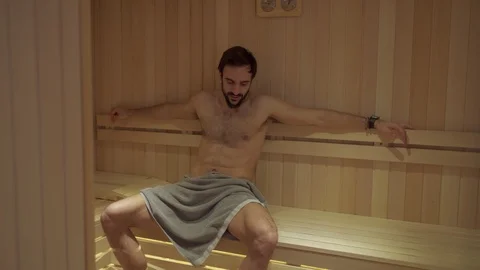 Muscular bearded man sweating in the spa sauna Stock Footage 127649028