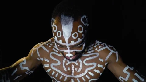 A muscular black man in white patterns and a necklace around his neck shaking Stock Footage 82233378