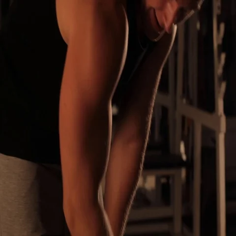 Muscular bodybuilder guy doing exercises with dumbbells in gym Stock Footage 69355215