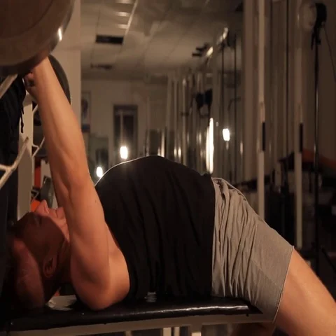 Muscular bodybuilder guy doing exercises. raises the bar. weightlifter Stock Footage 69426748