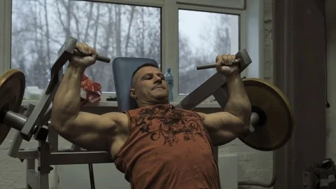 Muscular bodybuilder guy doing exercises in gym.Man working with weights in gym Stock Footage 70076465
