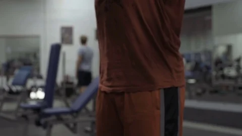 Muscular bodybuilder guy doing exercises in gym.Man working with weights in gym Stock Footage 70076524