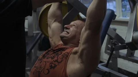 Muscular bodybuilder guy doing exercises in gym.Man working with weights in gym Stock Footage 70076545