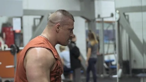 Muscular bodybuilder guy doing exercises in gym.Man working with weights in gym Stock Footage 70076558