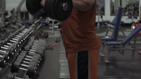 Muscular bodybuilder guy doing exercises in gym.Man working with weights in gym Stock Footage 70076582