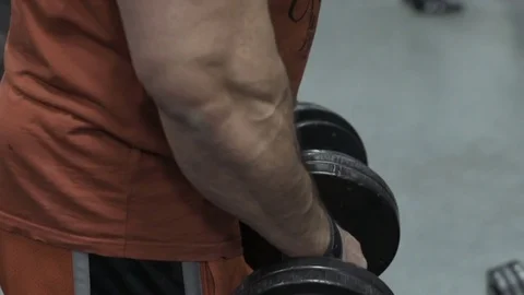 Muscular bodybuilder guy doing exercises in gym.Man working with weights in gym Stock Footage 70076713