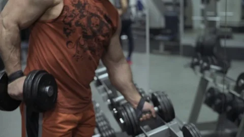 Muscular bodybuilder guy doing exercises in gym.Man working with weights in gym Stock Footage 70076718