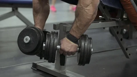 Muscular bodybuilder guy doing exercises in gym.Man working with weights in gym Stock Footage 70076791
