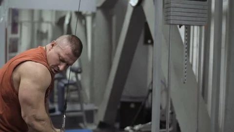 Muscular bodybuilder guy doing exercises in gym.Man working with weights in gym Stock Footage 70076828