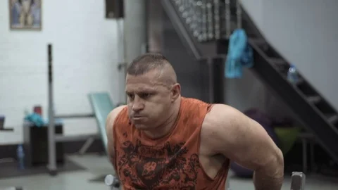 Muscular bodybuilder guy doing exercises in gym.Man working with weights in gym Stock Footage 70076912