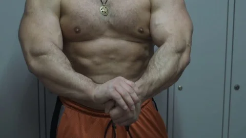 Muscular bodybuilder guy doing exercises in gym.Man working with weights in gym Stock Footage 70076968