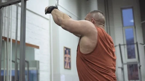 Muscular bodybuilder guy doing exercises in gym.Man working with weights in gym Stock Footage 70077046