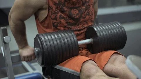 Muscular bodybuilder guy doing exercises in gym.Man working with weights in gym Stock Footage 70077232