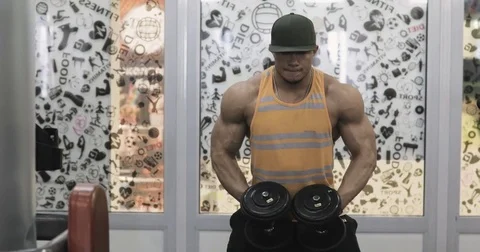 Muscular bodybuilder guy doing exercises in gym.Man working with weights in gym Stock Footage 75185704