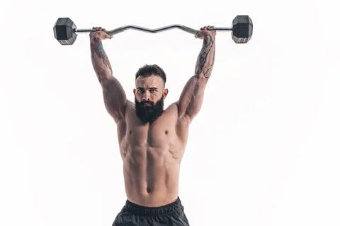 Muscular bodybuilder guy doing exercises with dumbbell over whit Stock Photos