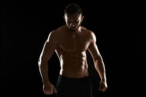 Muscular bodybuilder guy doing posing Stock Photos