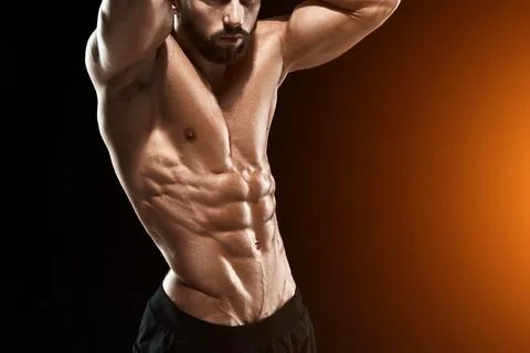 Muscular bodybuilder guy doing posing Stock Photos