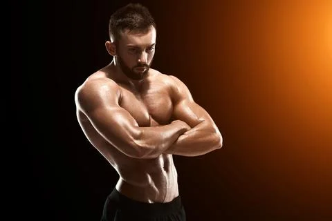 Muscular bodybuilder guy doing posing Stock Photos