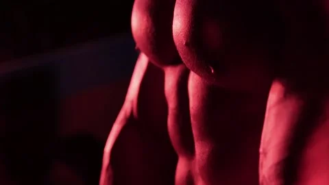 Muscular bodybuilder in red light. Stock Footage 132181797