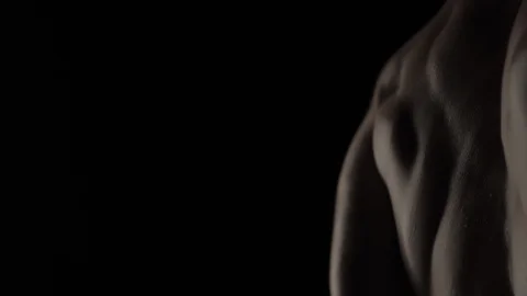 Muscular Bodybuilder Training on Black Background Stock Footage 128346375