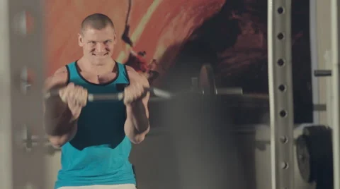 Muscular bodybuilder work out with a heavy barbell in gym Stock Footage 48992820