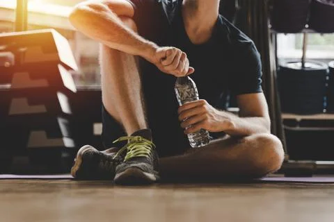 Muscular caucasian young handsome man taking a break relax and drinking water Stock Photos