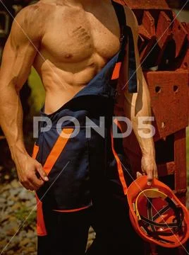 Muscular concept. Muscular body in working uniform. Muscular activity. Muscular Stock Photos
