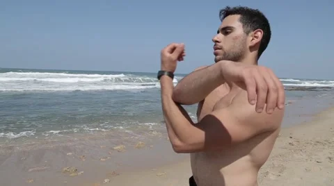 Muscular guy arm stretching Stock Footage 61460893