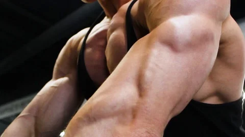 Muscular guy bodybuilder doing pushups from bench Stock Footage 113175861