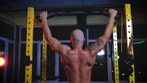 Muscular male bodybuilder doing pull ups at gym Stock Footage 145405395