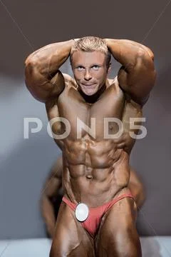 Muscular male flexing abs. Stock Photos