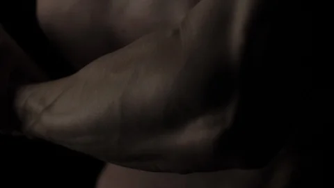 Muscular Man Bodybuilder. Man Posing On A Black Background, Shows His Muscles Video stock 128345802