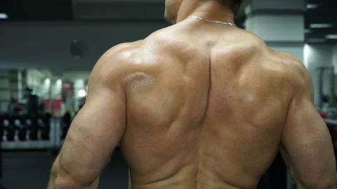 Muscular man bodybuilder posing with his back. Stock Footage 92156147