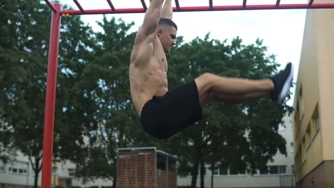 Muscular man doing abs exercise during his workout on the street Stock-Footage 116332773