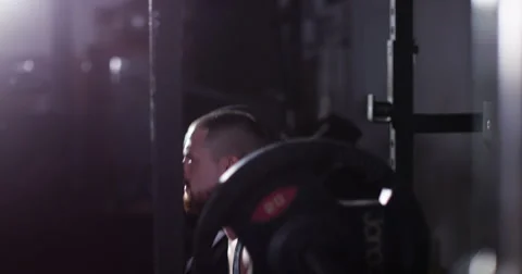 Muscular man doing barbell squats in a gym. Shot on RED Epic. Stock Footage 55900169