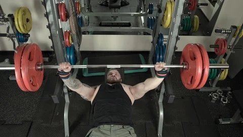 Muscular man doing bench press close-up 4k. Stock Footage 85588150