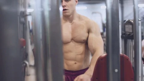 Muscular man doing exercise on triceps in the gym Stock Footage 70389669