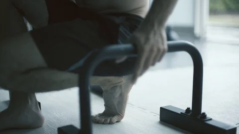 Muscular man doing a handstand on dip bars Stock Footage 127438763