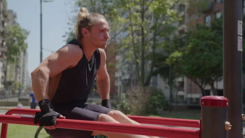 Muscular Man Doing L-Sit Dips during Outdoor Workout Video stock 260050481