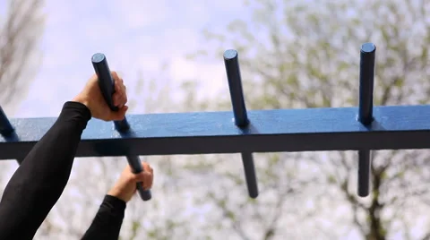 Muscular Man Doing Pull-Ups on Horizontal Bar. Big Hands Shot Stock Footage 62252787