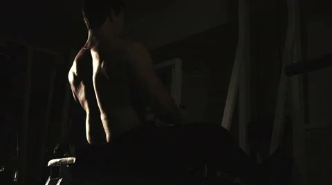 Muscular man doing pull-ups at gym, lowlight 스톡 동영상 68414719