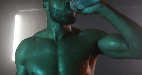 Muscular man drinking water while working out in the gym Stock Footage 116357879