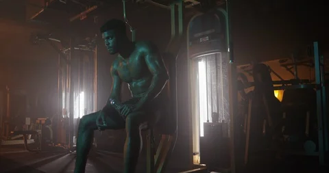 Muscular man drinking water while working out in the gym Stock Footage 116358477