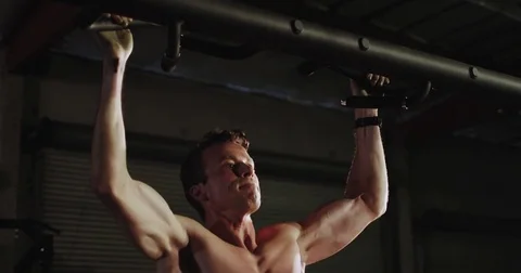 Muscular man exercises and does pull-ups Stock Footage 83324700