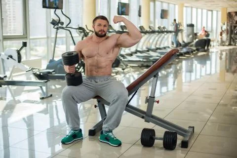 Muscular man in gym. Stock Photos