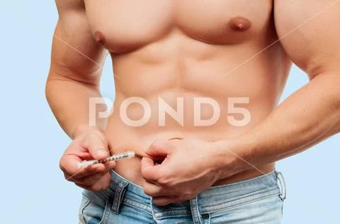 Muscular man injecting himself with steroids. Stock Photos