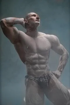 Muscular man with perfect abs posing in studio Stock-Illustration